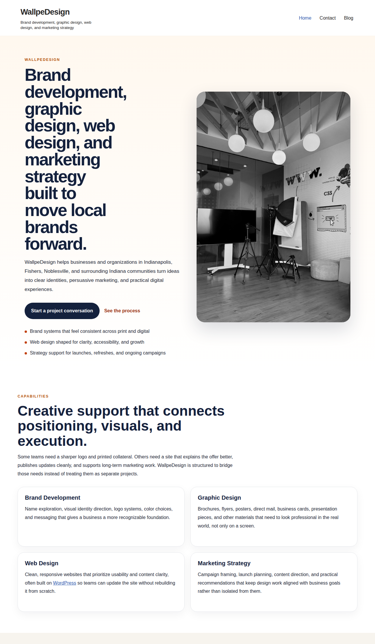 Screenshot of the WallpeDesign homepage showing a clear small-business web design layout