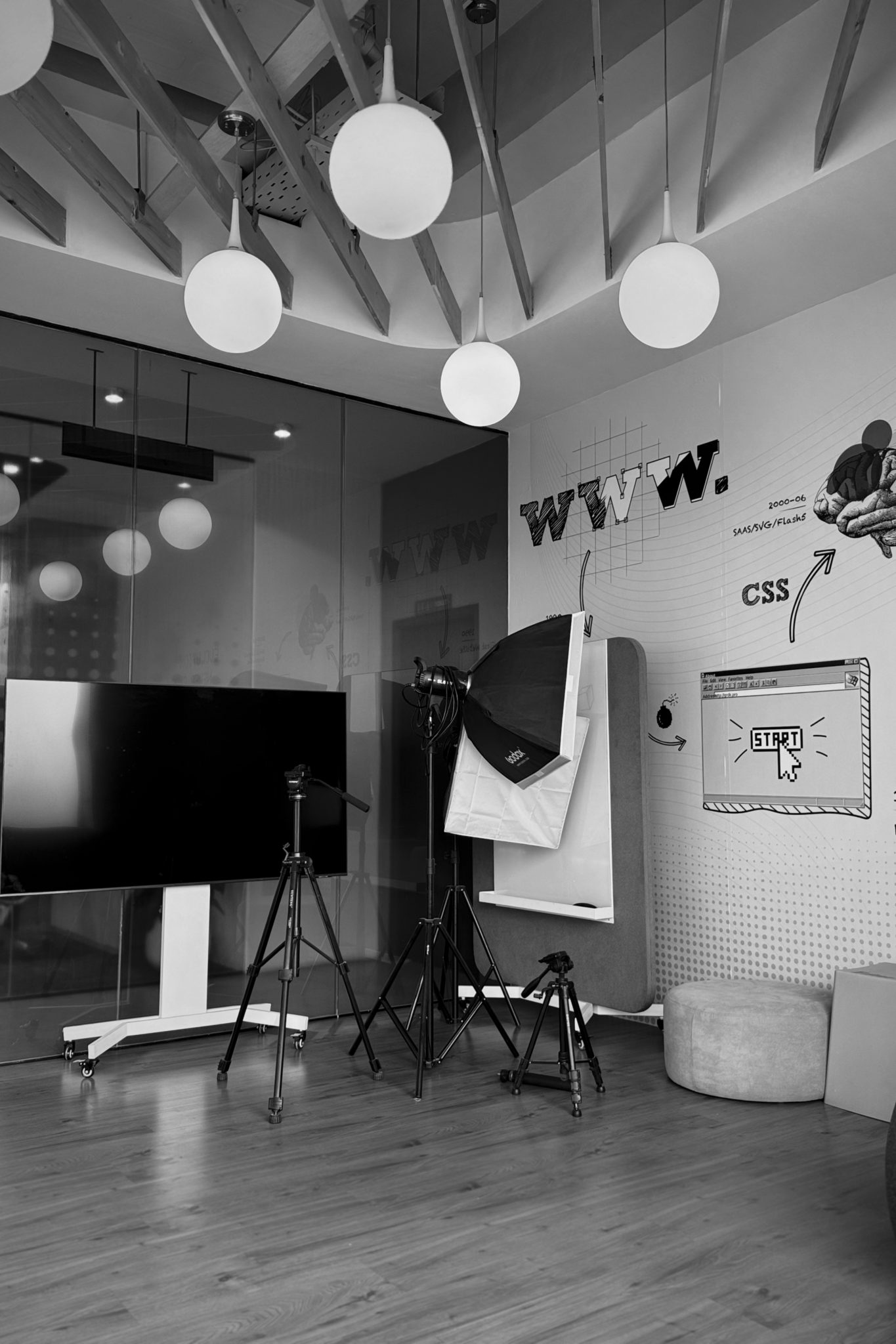 Creative workspace with a large monitor, lighting equipment, and modern design tools.